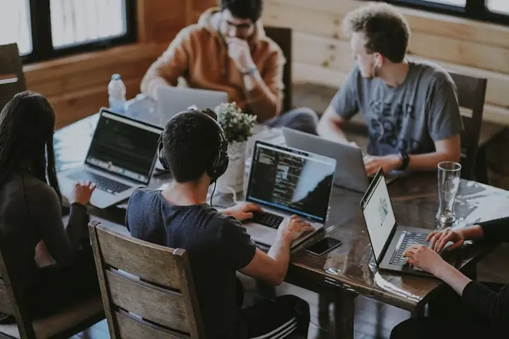 IT professionals collaborating on laptops—hands-on Microsoft 365 and Intune support for Mountain Home businesses